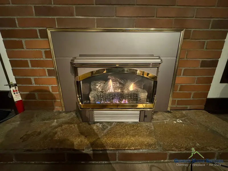 Gas fireplace brass trim arched insert brick lit — Bellevue