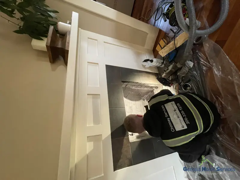 Genesis technician servicing a gas fireplace insert Seattle