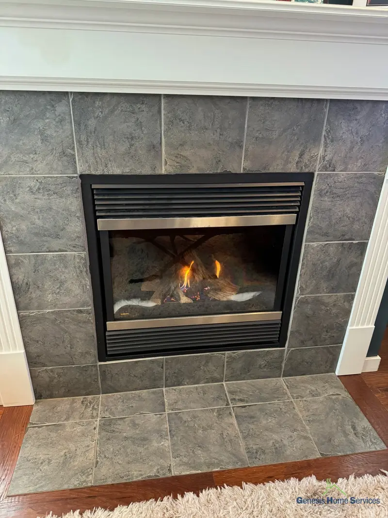 Gas fireplace grey tile surround with gas logs lit
