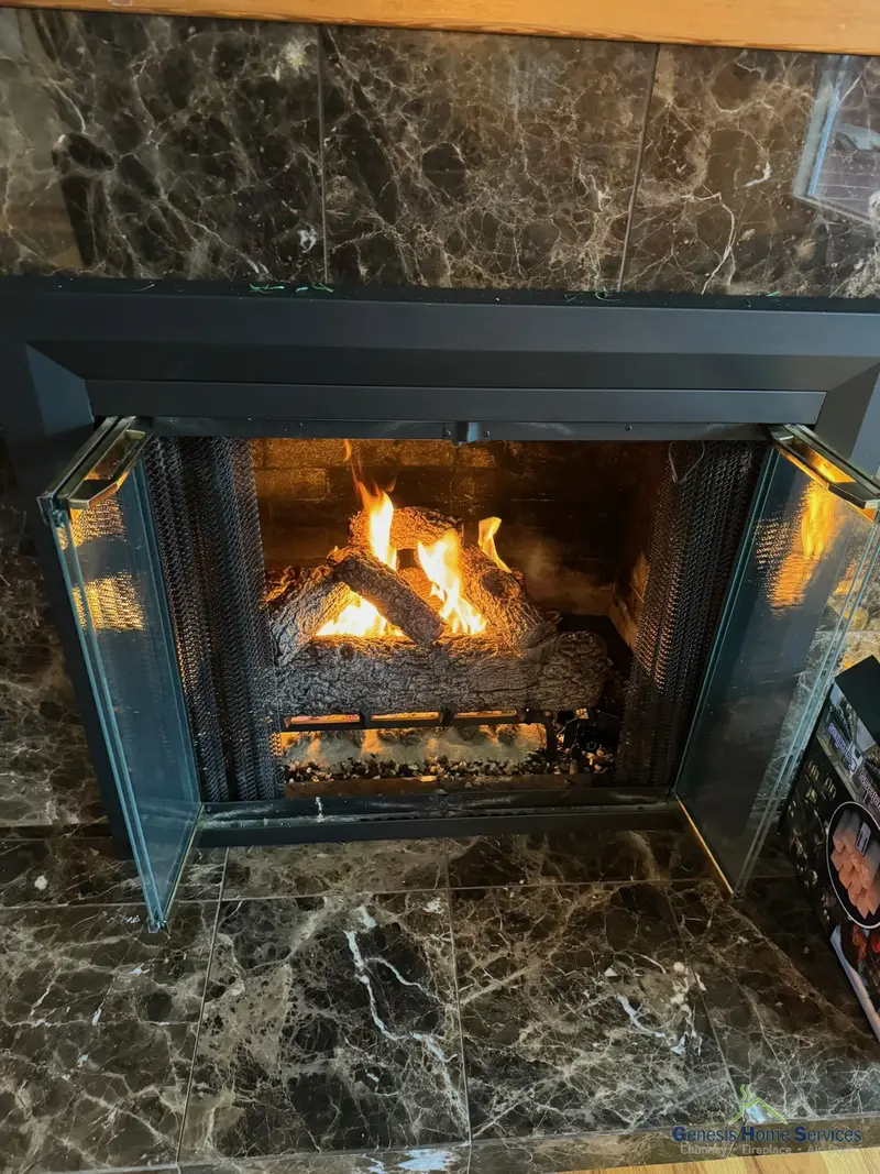 Gas fireplace marble surround black insert lit — Bothell